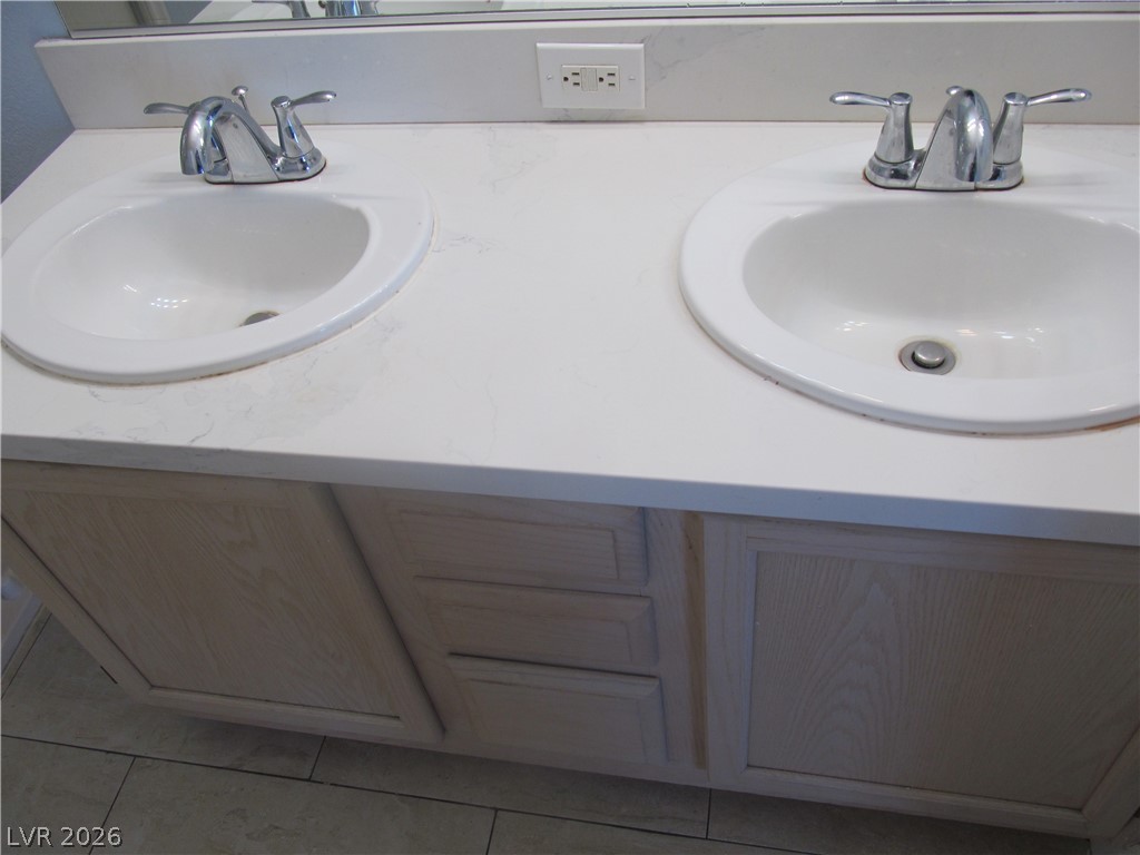 7950 West Flamingo Road, Unit 2048 Las Vegas, NV 89147 - Photo 18 of 24 Double vanity with ample counter space creates a functional primary bathroom.