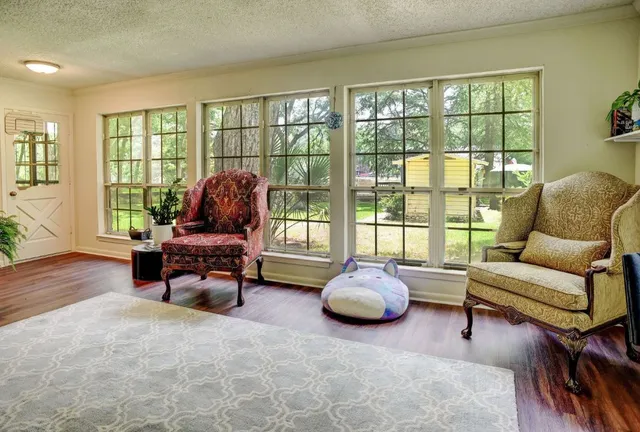 a living room with furniture and a floor to ceiling window