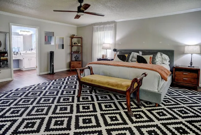 a bed room with a bed and a rug