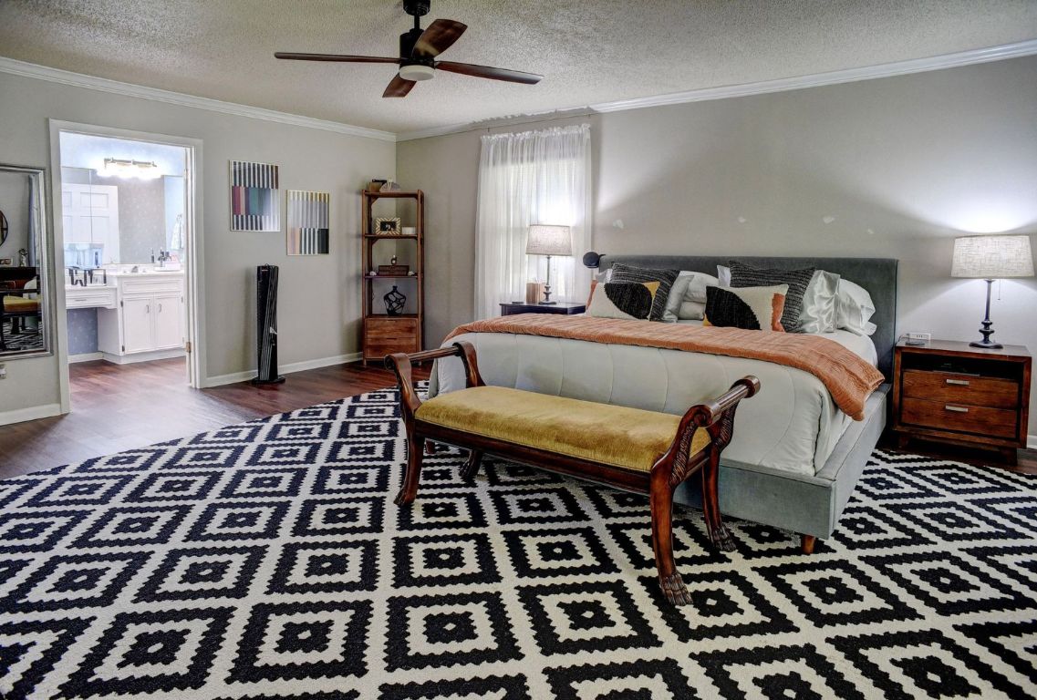 4703 Laguna Lane Austin, TX 78746 - Photo 14 of 32 a bed room with a bed and a rug