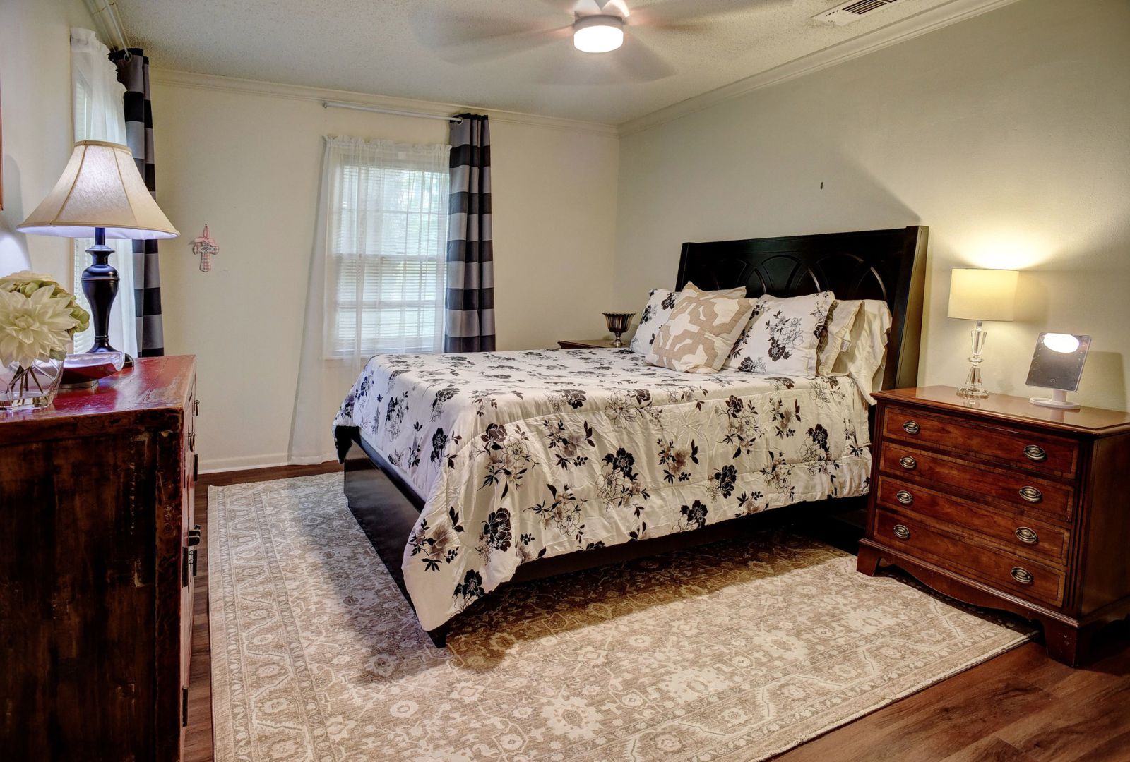4703 Laguna Lane Austin, TX 78746 - Photo 16 of 32 a bedroom with a bed and a lamp on dresser