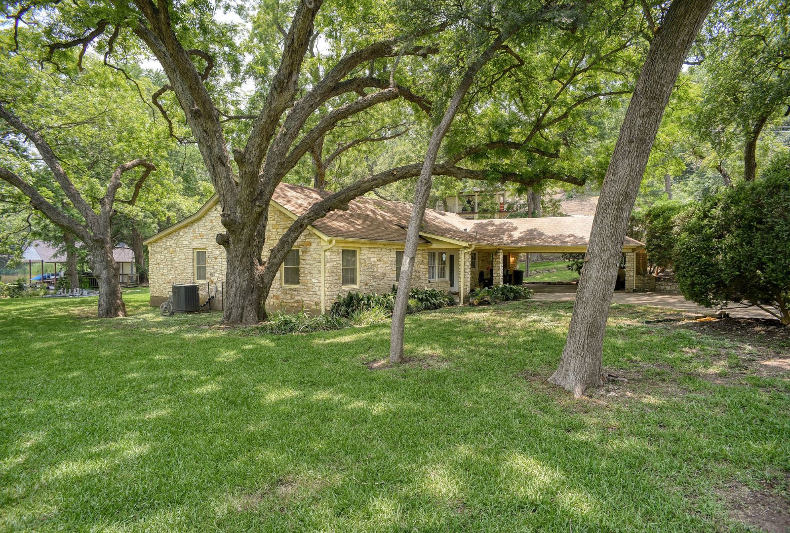 4703 Laguna Lane Austin, TX 78746 - Photo 19 of 32 a house with trees in the background