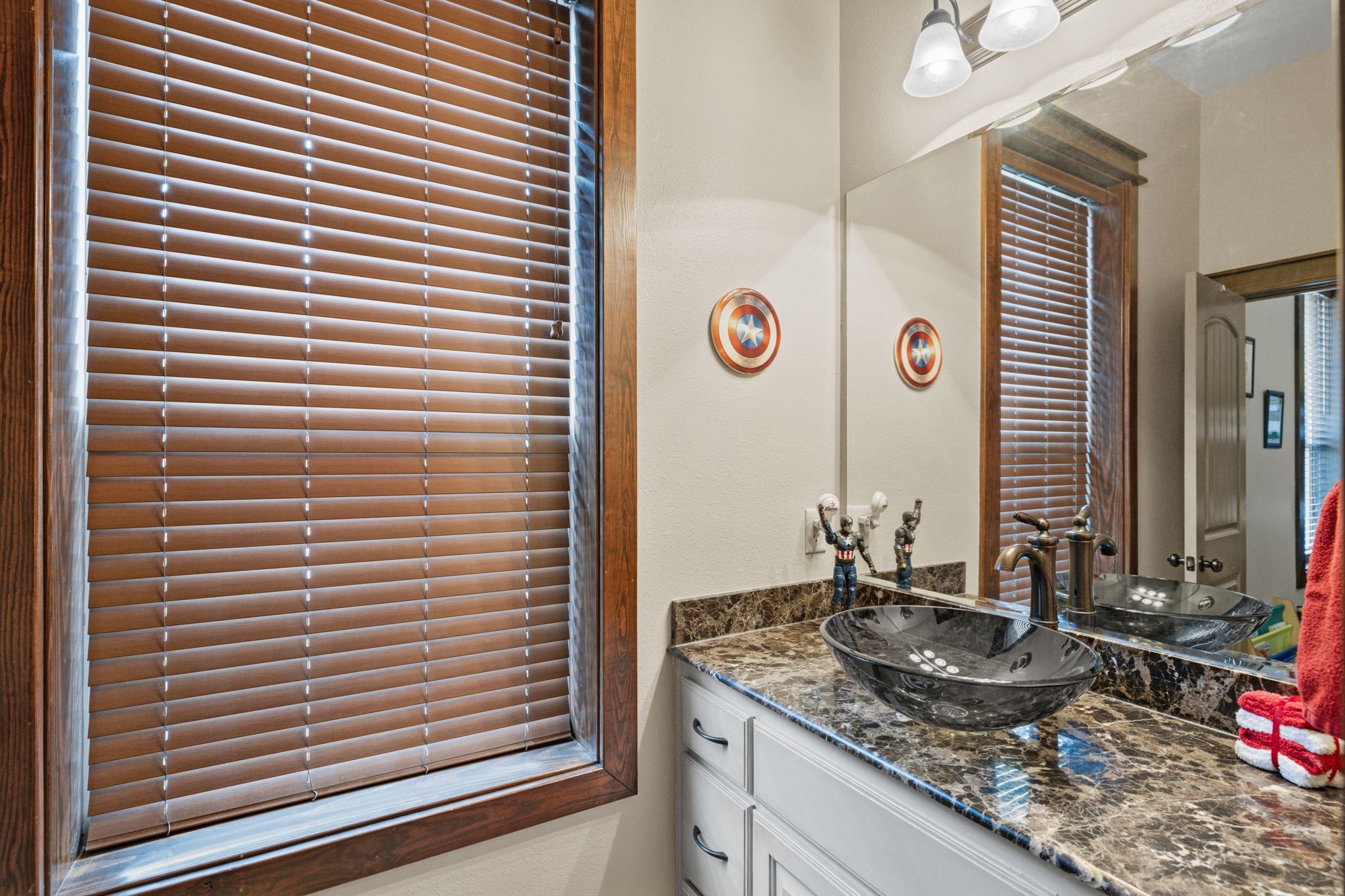4999 Pin Oak Road Franklin, TX 77856 - Photo 22 of 47 a bathroom with a granite countertop sink and a window