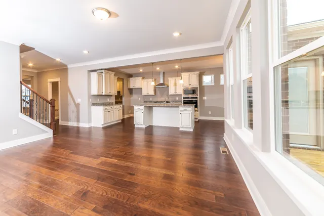 a view of a living room and dining room with wooden floor
