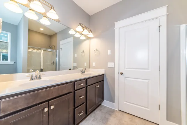 a bathroom with a double vanity sink and a mirror