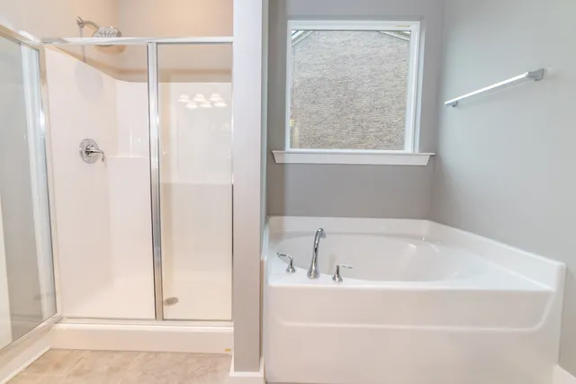 a white bath tub sitting next to a shower
