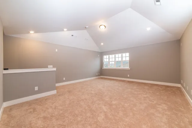 an empty room with windows and closet in a room