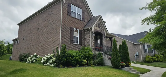 a front view of a house with garden