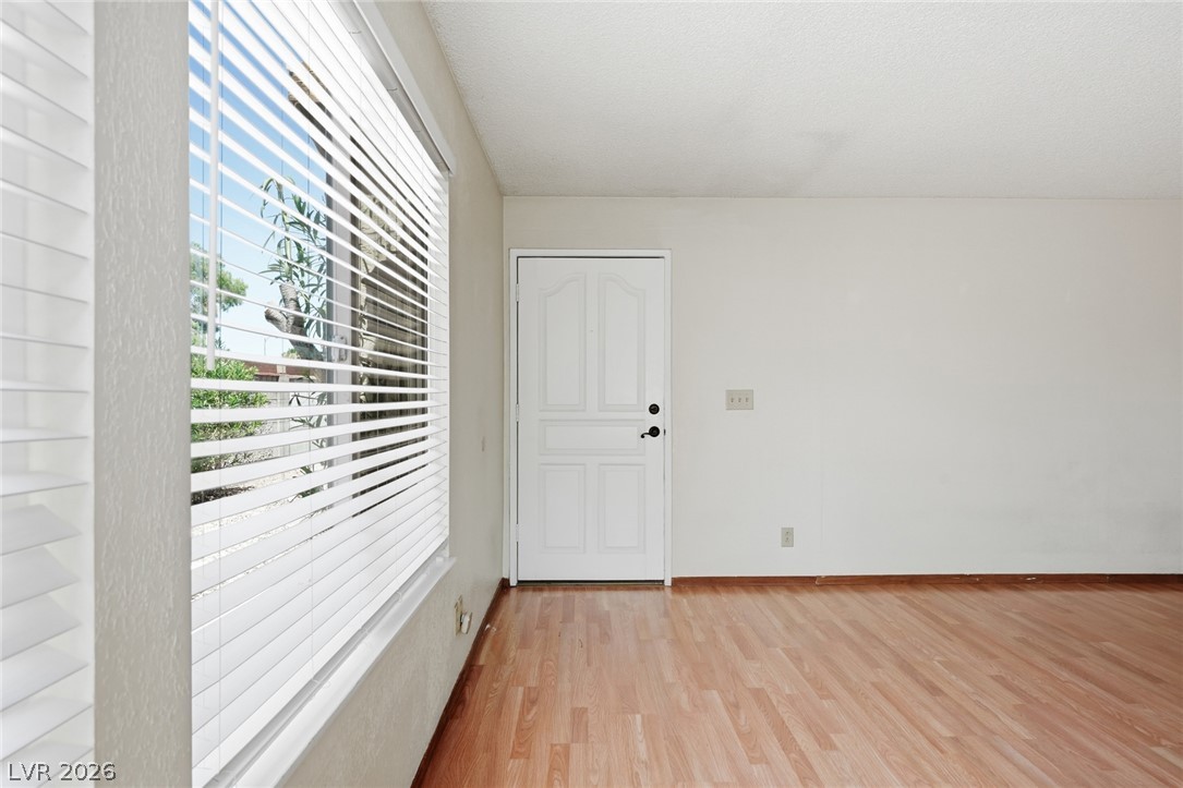 3971 Spring Leaf Drive Las Vegas, NV 89147 - Photo 48 of 48 Natural light streams through the window, illuminating the wood-like flooring and welcoming entryway.