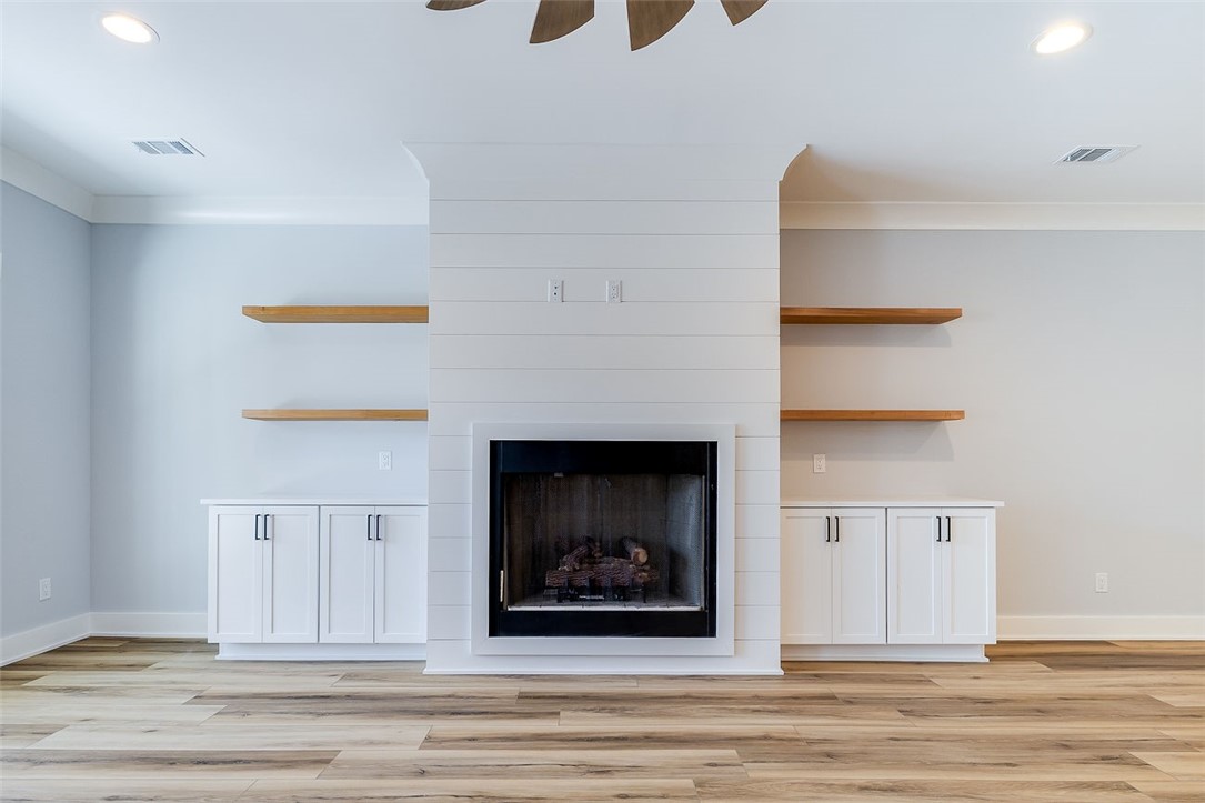 2014 Marshview Drive Northeast Townsend, GA 31331 - Photo 10 of 59 Fireplace in Great Room with Built-in lower cabinets & floating shelves!
