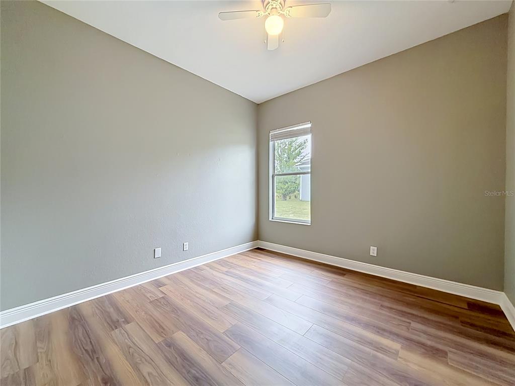 28549 Shirley Shores Road Tavares, FL 32778 - Photo 30 of 65 an empty room with wooden floor and windows