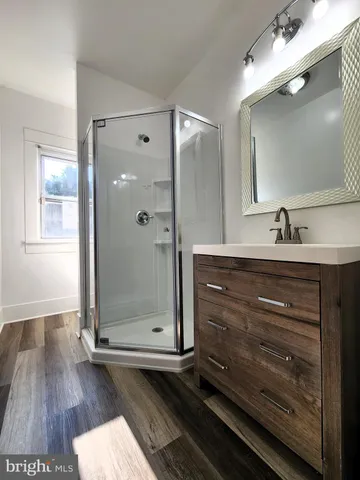 a bathroom with a sink a mirror and shower