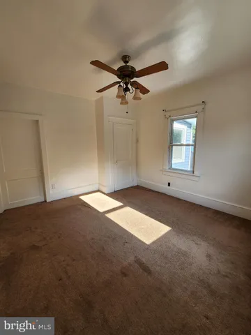 an empty room with a empty space and a ceiling fan