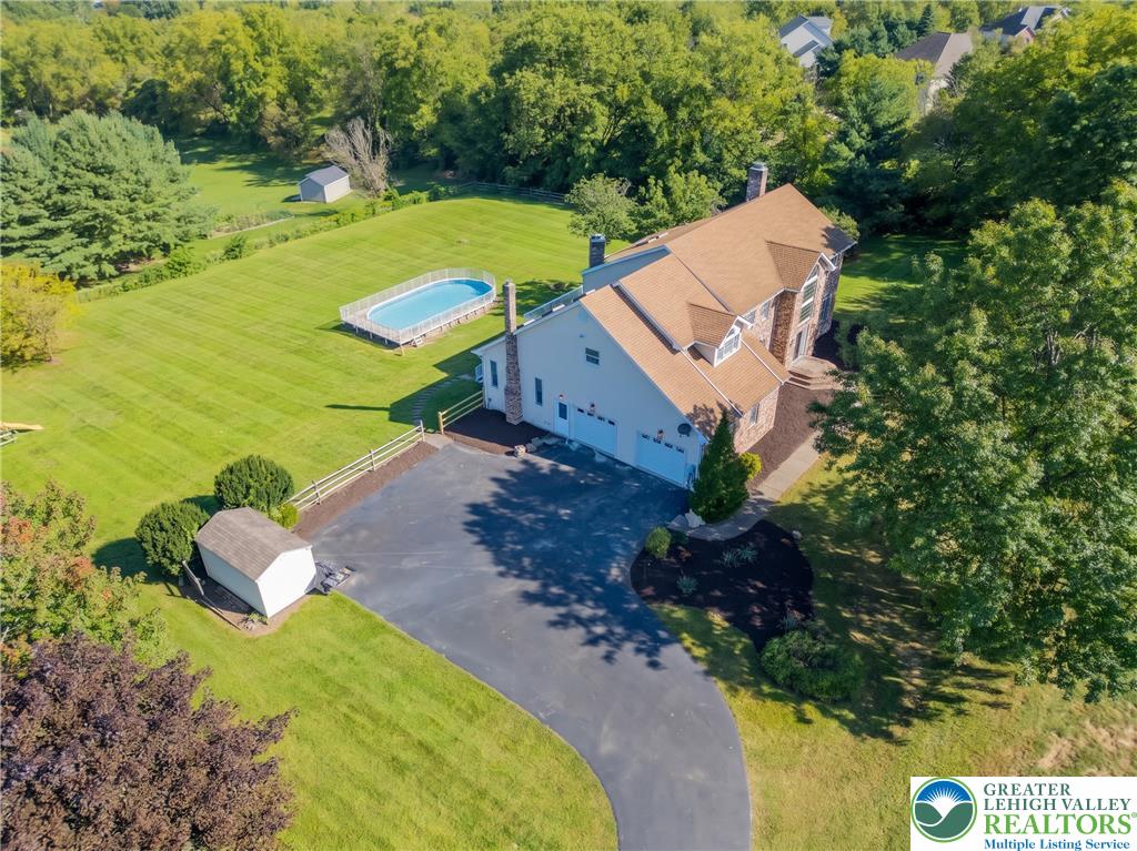 630 Clearfield Road Nazareth, PA 18064 - Photo 8 of 100 A spacious driveway leads to this multi-level home nestled in a lush, expansive lawn.