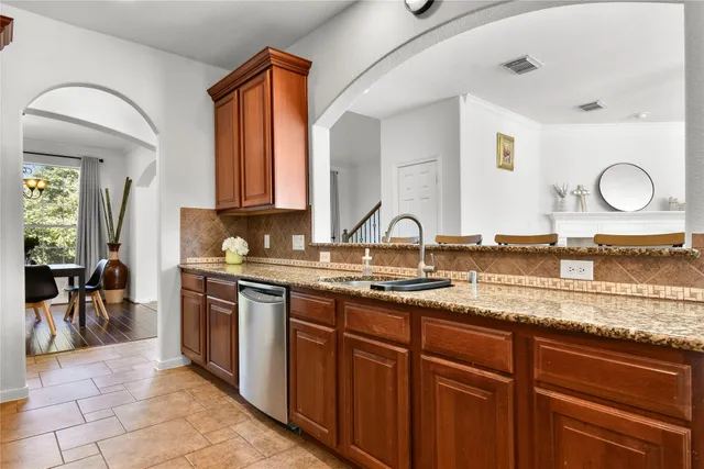 a bathroom with a granite countertop sink a mirror and a cabinets