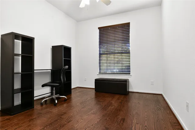 a view of workspace with wooden floor windows