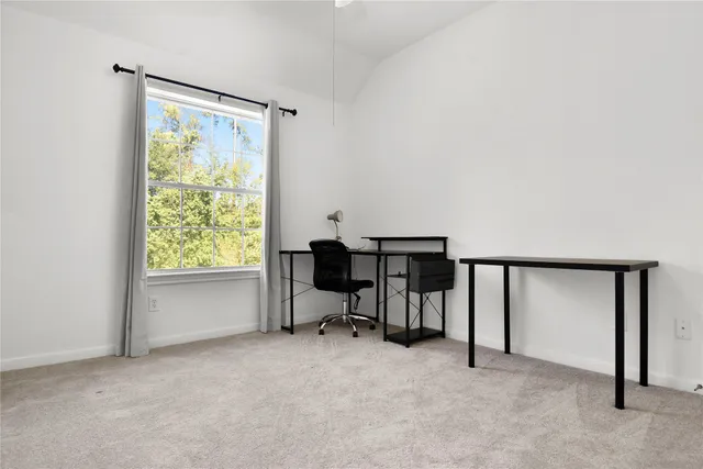 a view of workspace with furniture and a window
