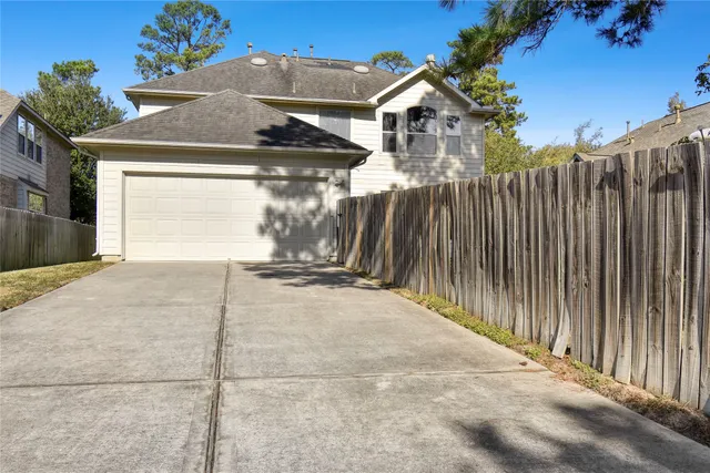 a view of a house with a wooden fence