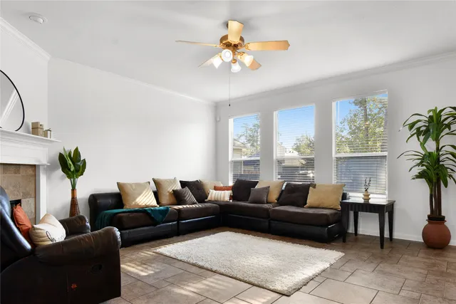 a living room with furniture a chandelier and a potted plant