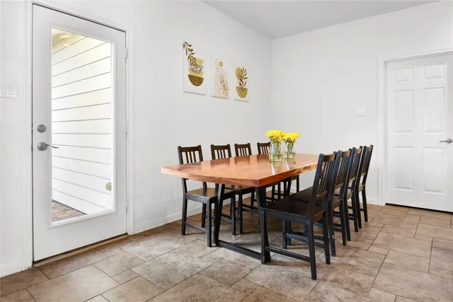 a view of a dining room with furniture and window