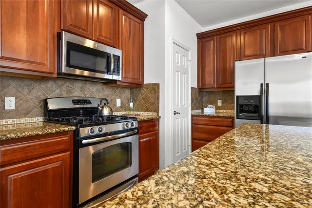 a kitchen with a stove microwave and refrigerator