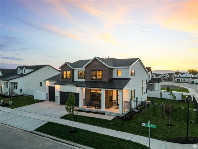 2458 West Aurora Avenue, Unit 287 Mapleton, UT 84664 - Photo 1 of 24 View of front of home featuring covered porch, driveway, a garage, a metal roof, and a residential view