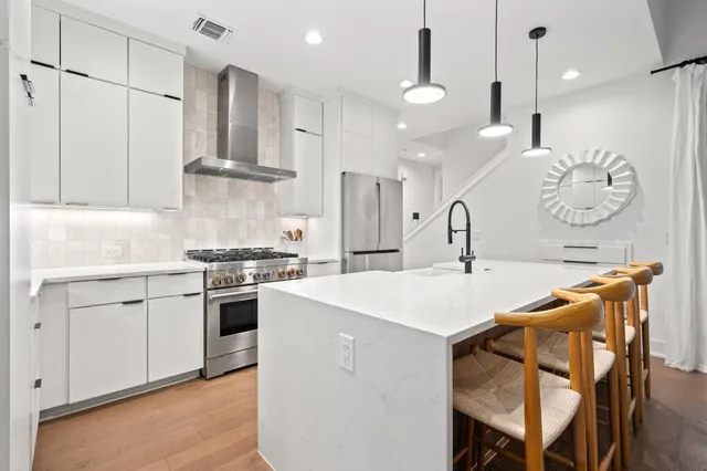 a kitchen with stainless steel appliances granite countertop a refrigerator and a sink