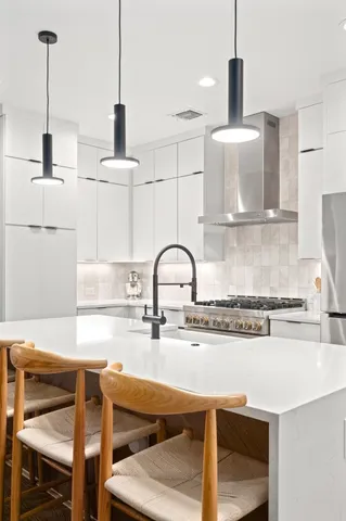 a kitchen with stainless steel appliances kitchen island a sink and cabinets