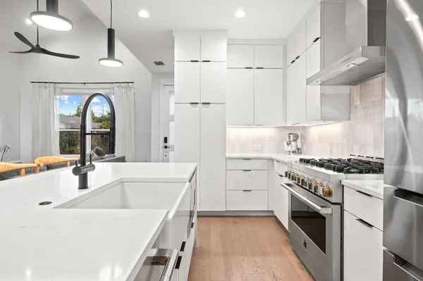 a kitchen with a table chairs and appliances