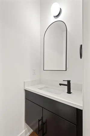 a large kitchen with kitchen island a stove a sink a oven and a chandelier