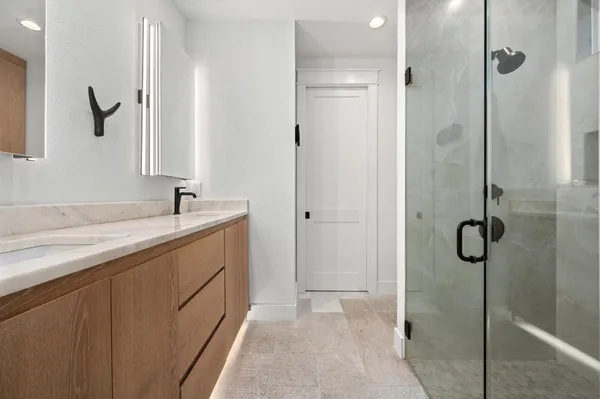 a bedroom with a large bed and a chandelier