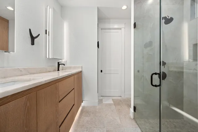 a bedroom with a large bed and a chandelier