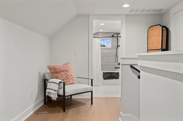 a bathroom with a bathtub shower sink vanity and toilet