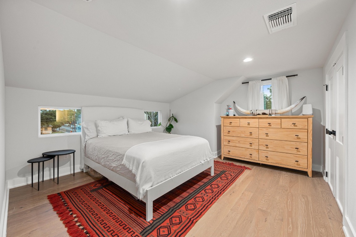 2104 East 2nd Street, Unit 1 Austin, TX 78702 - Photo 26 of 39 a bedroom with a bed and furniture