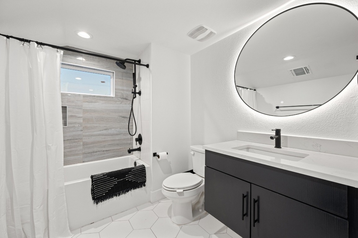 2104 East 2nd Street, Unit 1 Austin, TX 78702 - Photo 27 of 39 a bathroom with a sink a toilet and shower