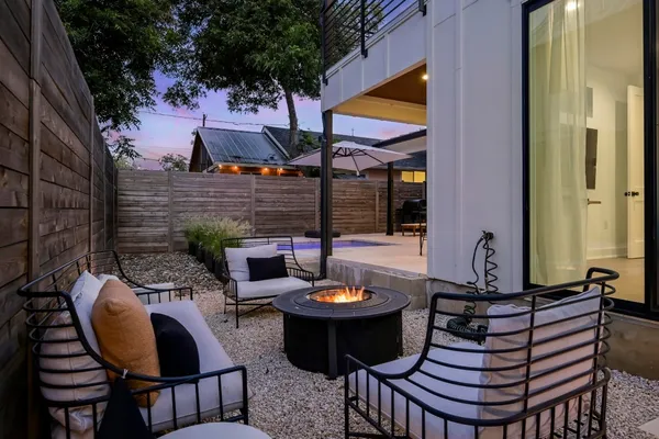 a view of a patio with table and chairs under an umbrella