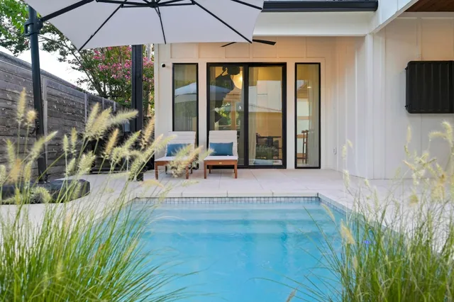a living room with stainless steel appliances kitchen island granite countertop furniture and a fireplace