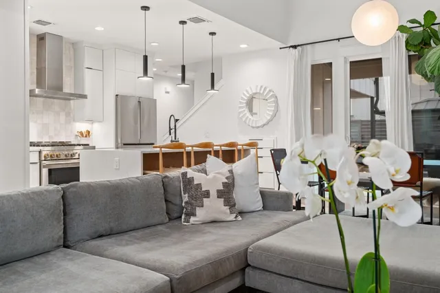 a living room with furniture chandelier and a large window