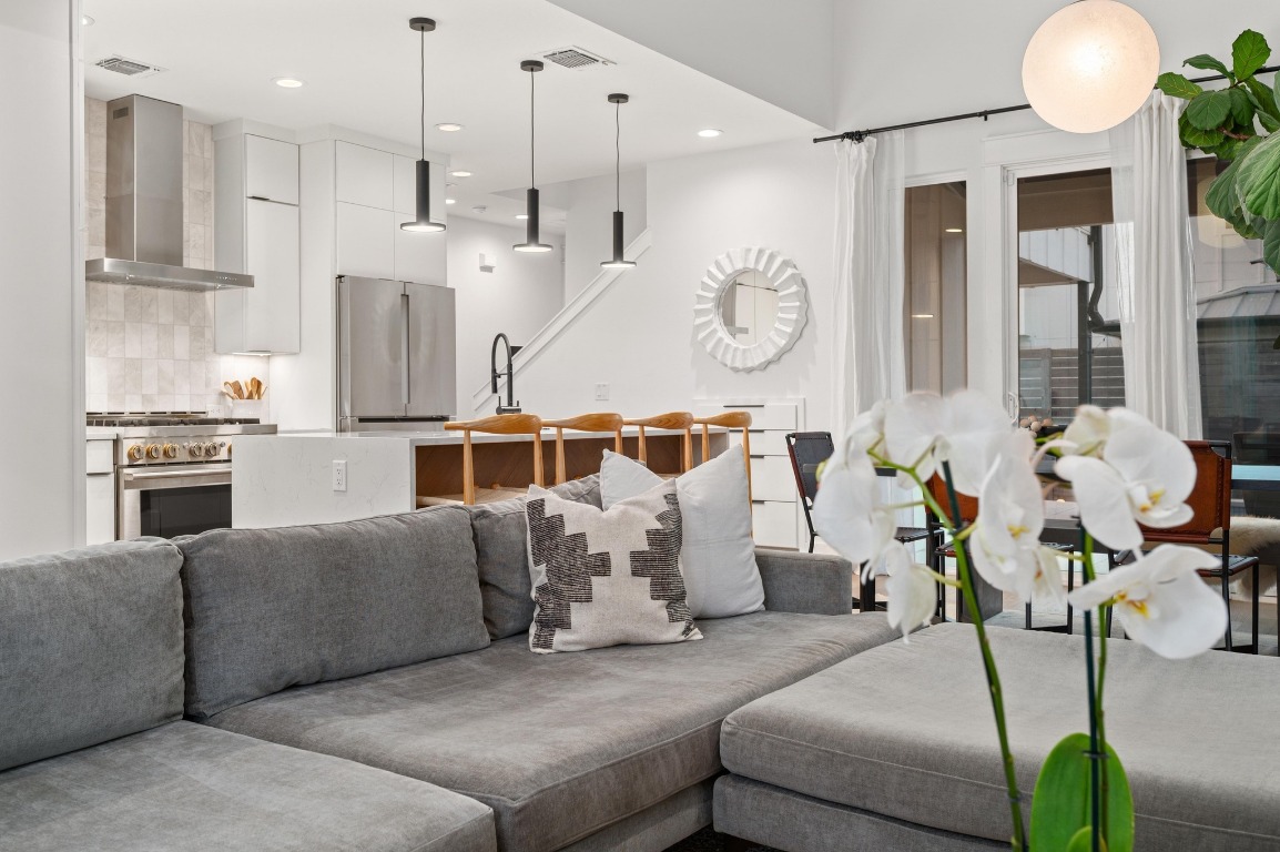 2104 East 2nd Street, Unit 1 Austin, TX 78702 - Photo 5 of 39 a living room with furniture and a chandelier