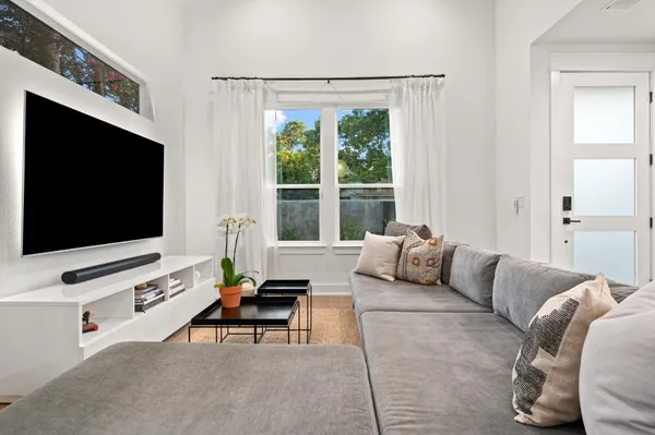 a living room with furniture and a chandelier