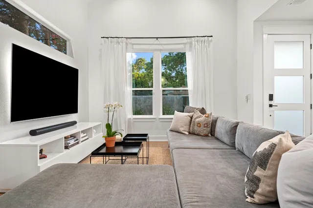 a living room with furniture and a chandelier