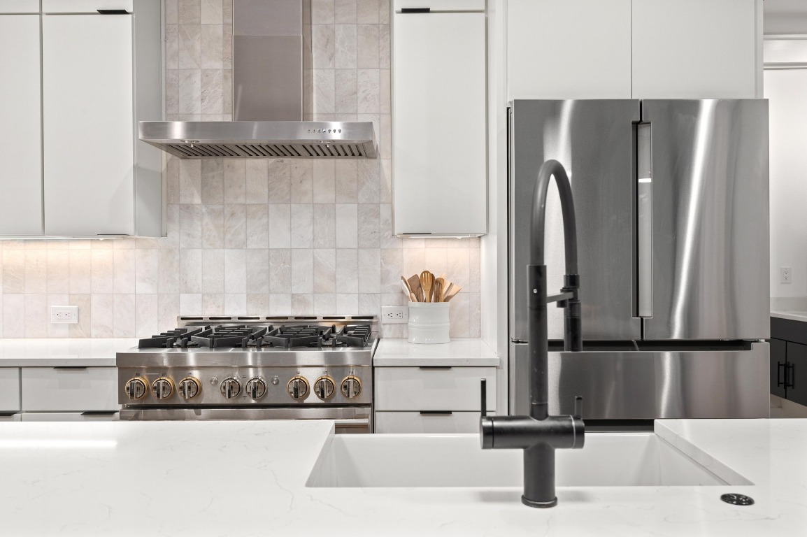 2104 East 2nd Street, Unit 1 Austin, TX 78702 - Photo 9 of 39 a kitchen with stainless steel appliances granite countertop a refrigerator and a sink