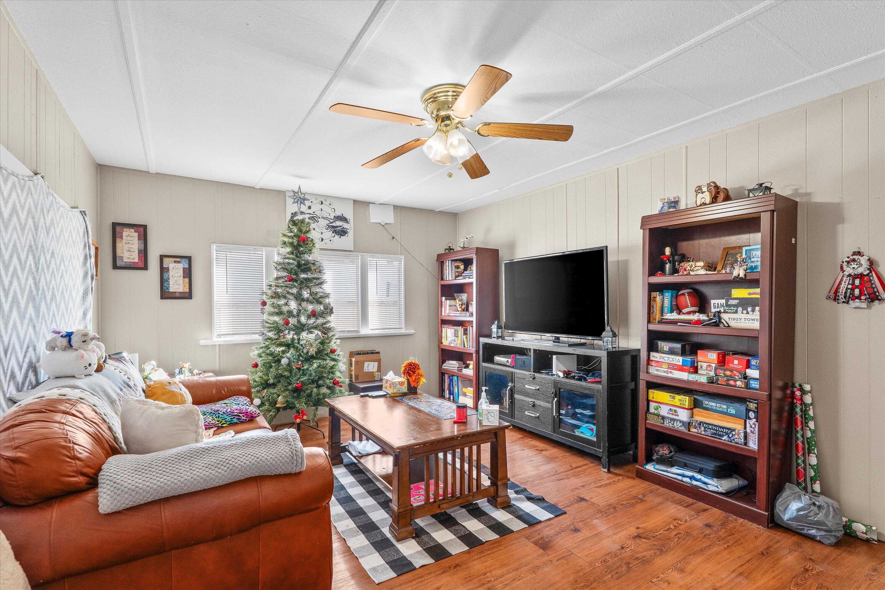 204 Austin Street Levelland, TX 79336 - Photo 2 of 13 a living room with furniture and a flat screen tv
