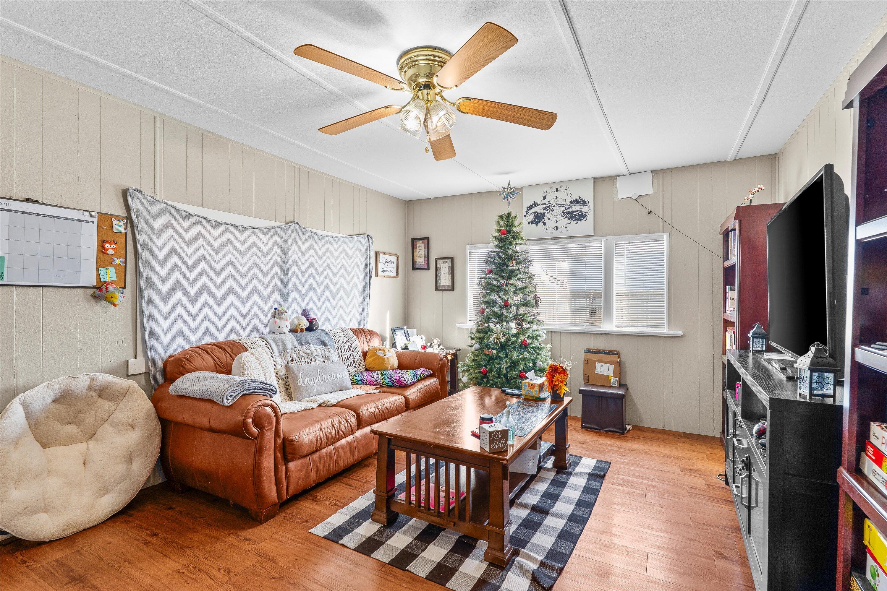 204 Austin Street Levelland, TX 79336 - Photo 3 of 13 a living room with furniture and a flat screen tv