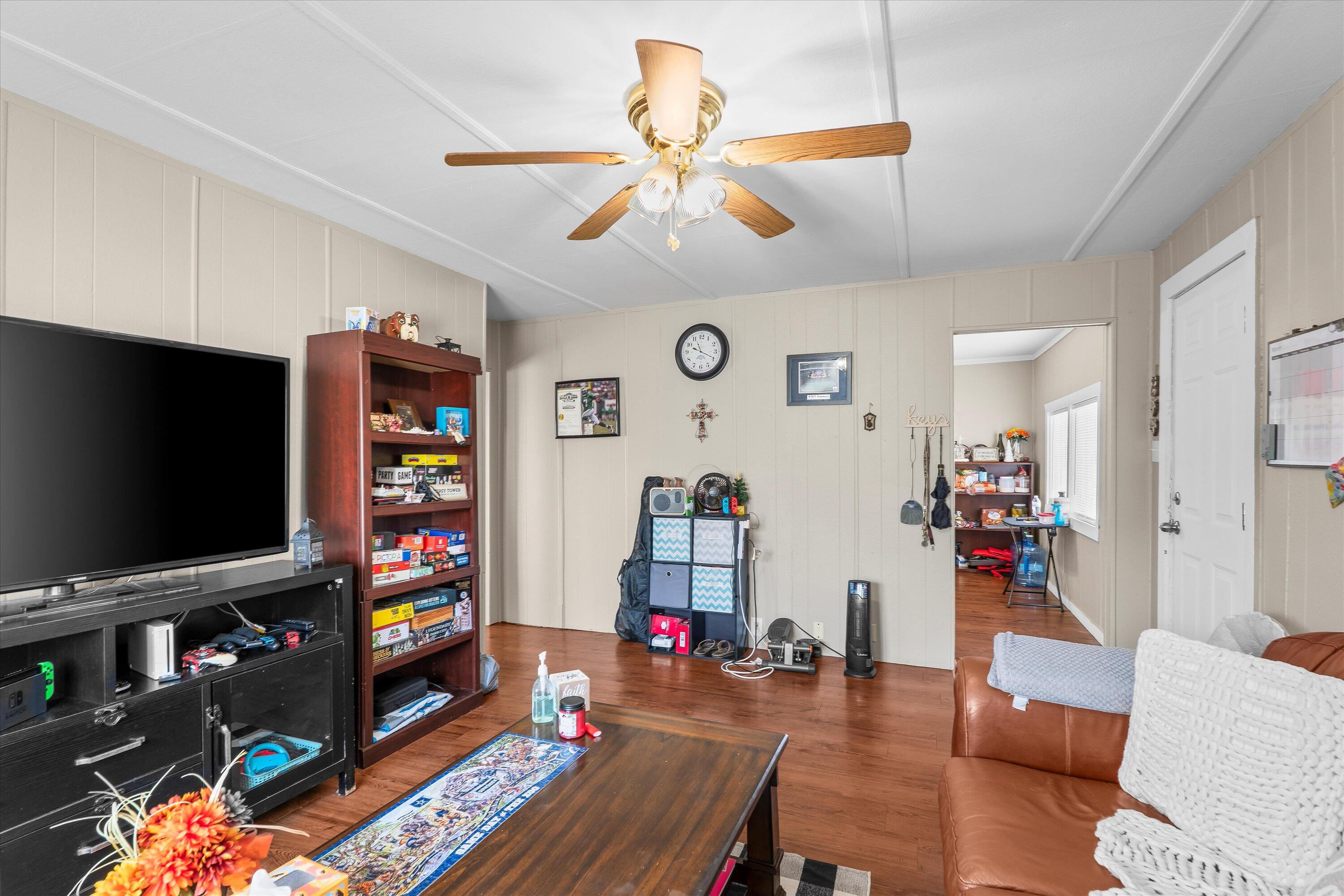204 Austin Street Levelland, TX 79336 - Photo 5 of 13 a living room with furniture and a flat screen tv