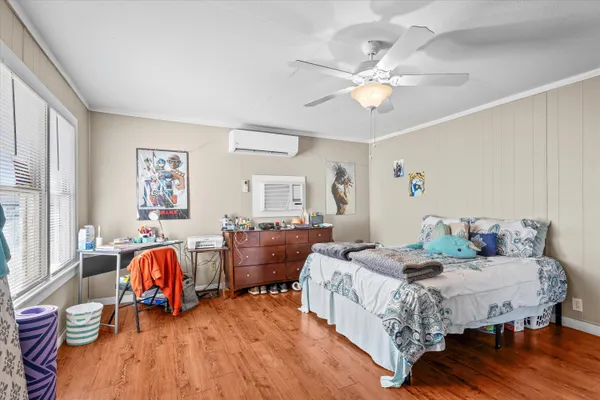 a bedroom with a bed and a chandelier