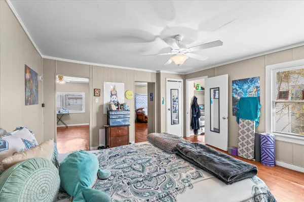 a living room with a bed furniture and a large window