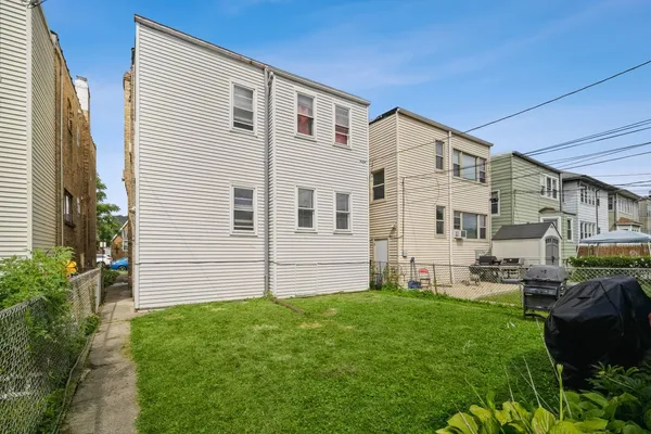 a view of house with backyard