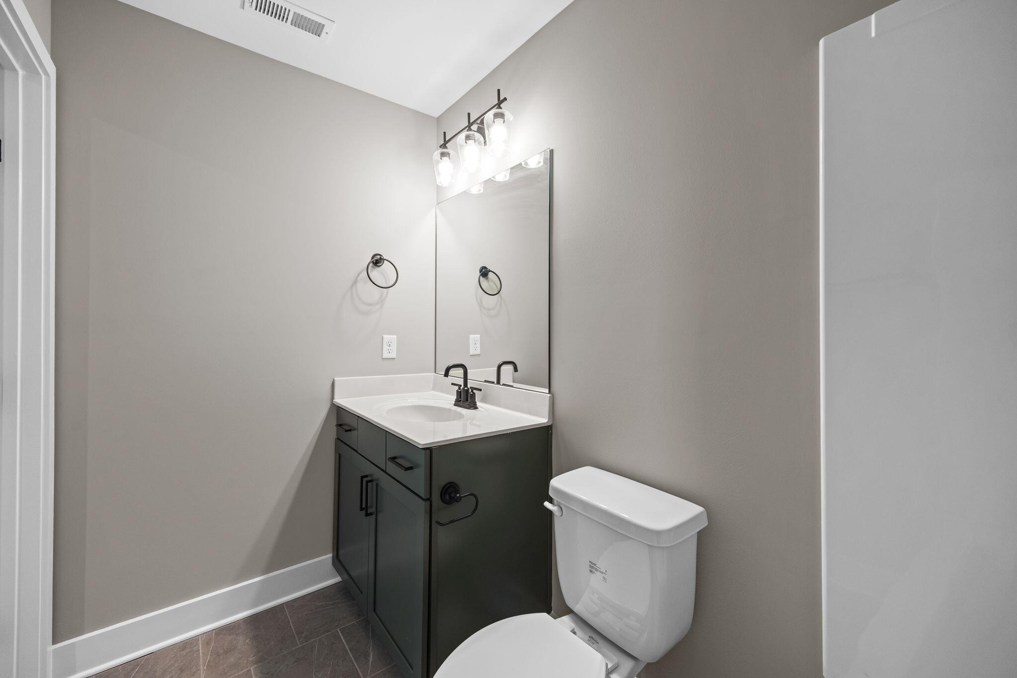 2413 East 17th Street Chattanooga, TN 37404 - Photo 12 of 42 a bathroom with a toilet sink and mirror