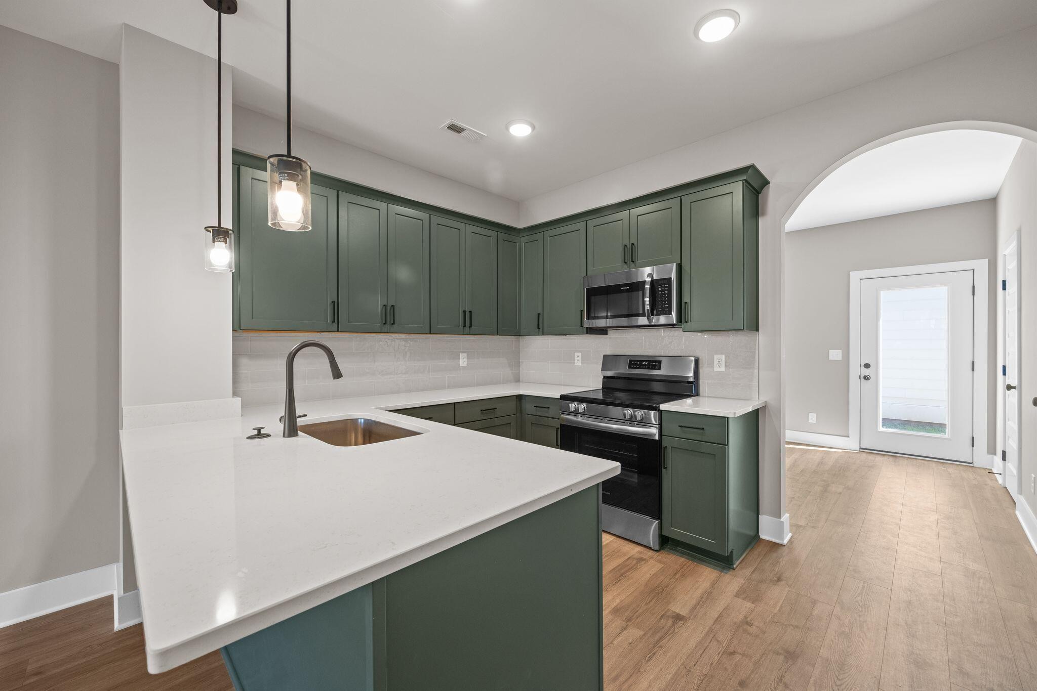 2413 East 17th Street Chattanooga, TN 37404 - Photo 2 of 42 a kitchen with a sink a stove and refrigerator